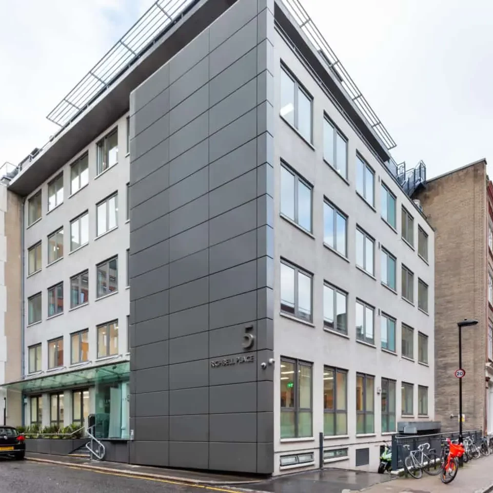 Exterior of Richbell Place, located in Holborn, London, surrounded by parked cars and bicycles.